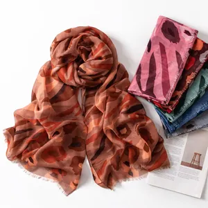Close-up of ethnic printed lightweight summer scarves in multiple colors with tassels