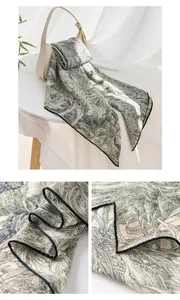 Detailed macro view of vintage floral print on luxury silk wool green square scarf
