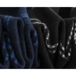 Close-up of soft blue and black plaid fabric texture on men's winter scarf