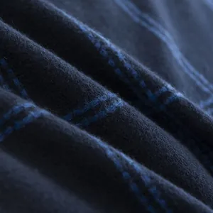 Close-up of the soft blue plaid fabric and neat stitching of this men's scarf.