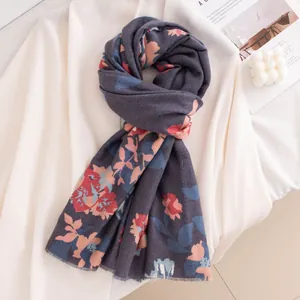 Macro detail of soft vintage floral print scarf made of warm imitation cashmere fabric