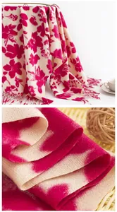 Macro view of soft imitation cashmere scarf featuring vibrant pink floral patterns.