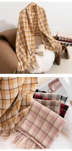 Detailed view of multiple retro Maillard plaid scarves with soft textures and fringes.