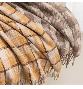 Close-up detail of thick vintage plaid scarf showing soft woven texture and tassels.