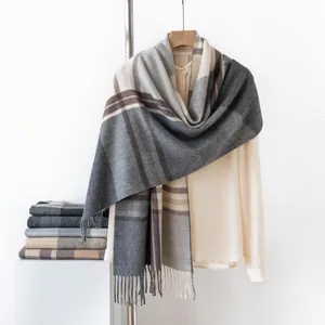 Detailed view of thick checkered cashmere-like scarf with fringe edges for winter