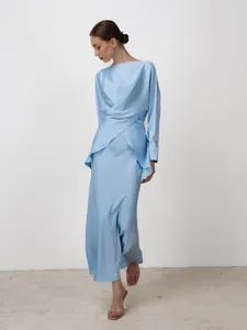 Detail shot of a luxurious light blue satin evening gown with elegant waist draping
