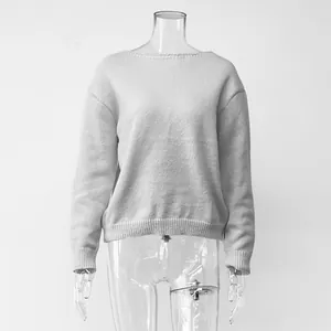 Minimalist white long-sleeved knit sweater displayed on a transparent mannequin