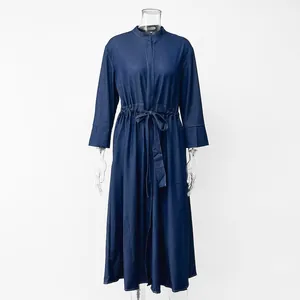 Close-up detail of navy blue denim maxi dress with stand collar and drawstring waist.