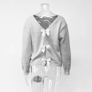 Detailed view of sexy deep V backless knit sweater with three white satin bows.