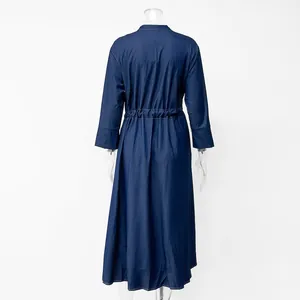 Back view of a long-sleeved navy blue denim maxi dress on a clear mannequin