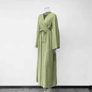 Elegant sage green wrap maxi dress featuring long flare sleeves and a self-tie waist belt