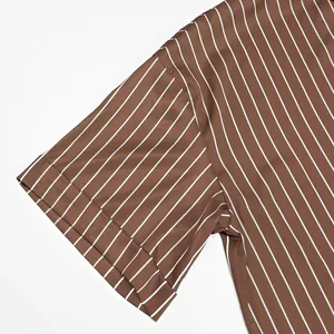Détail du haut en satin marron à rayures avec une texture de tissu lisse et brillante