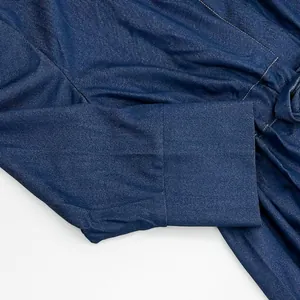 Detail shot of the sleeve cuff on a dark blue long denim dress with clean stitching