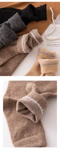 Macro detail showing the soft texture of knitted cashmere socks cuff with white stitching