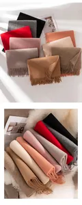 Various soft solid color wool scarves stacked to show thick texture and fringes