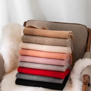Soft and thick solid color wide wool scarves stacked for cozy winter warmth and style