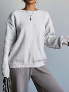 Close-up detail of soft light grey knitted long sleeve sweater showing ribbed textures.