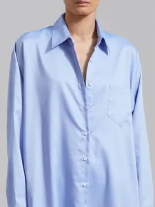 Close-up of a light blue long-sleeved shirt dress with chest pocket and button-down collar