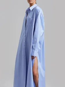 Detailed side view of a light blue long-sleeved maxi shirt dress with high side slit