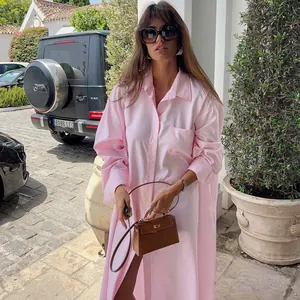 Close-up detail of a long pink French style shirt dress perfect for beach resort wear