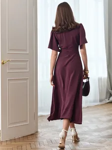 Back view of an elegant purple midi dress with short sleeves and a flowing skirt.