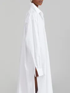 Detailed side view of a white oversized maxi shirt dress with high side slit