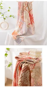 Detail of double-sided print mulberry silk scarf with floral and tropical leaf patterns