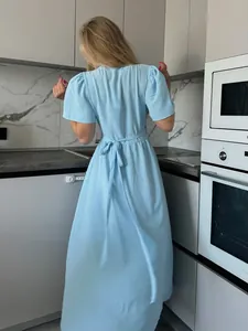 Back view of elegant light blue short-sleeved long dress with waist tie