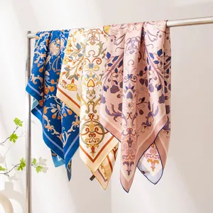 Elegant mulberry silk square scarves with luxury floral prints on a display rack