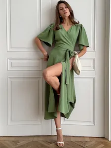 Elegant green wrap maxi dress featuring a stylish high leg slit and flutter sleeves