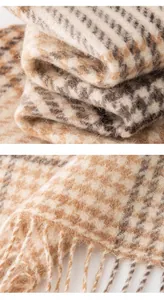 Detailed close-up showing soft wool texture and fringe of houndstooth plaid scarf