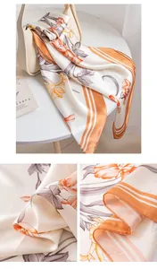 Detailed macro view of orange floral mulberry silk scarf texture and rolled hem