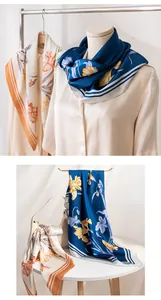 Detailed view of luxury camellia floral mulberry silk scarves in blue and beige tones.