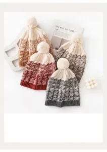 Close-up of four soft wool blend knitted beanies with pom-poms in various colors
