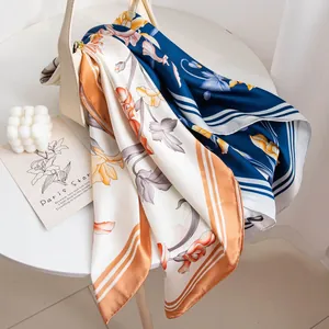 Elegant mulberry silk square scarf with retro camellia floral print on a white table