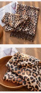 Close-up of luxury leopard print scarf with tassels in a warm lifestyle setting