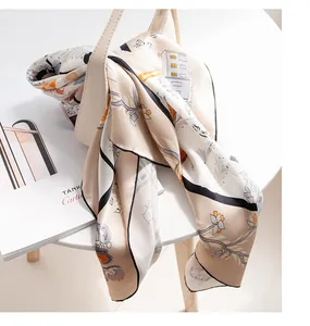 Detailed shot of a luxury mulberry silk scarf with architectural and floral patterns.