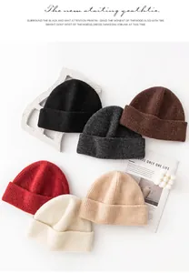 Close-up detail of various soft 93% wool knitted beanies in different warm colors