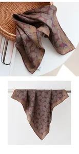 Detailed view of a maroon paisley silk square scarf displayed in a wicker basket.
