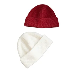 Pair of winter wool knit beanies in red and off-white on a clean white background.