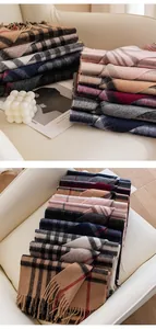 Detail view of various multi-colored plaid wool scarves with soft fringe edges