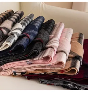 Close-up of stacked soft wool scarves in various classic checkered and striped winter patterns.