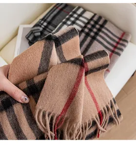 Detailed macro view of a classic checkered wool scarf showcasing soft texture and fringed edges
