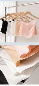 Detail view of premium silk sun protection neck gaiters in various elegant colors on a rack
