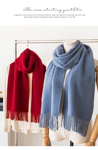 Close-up view of premium solid wool scarves with decorative tassels in red and blue