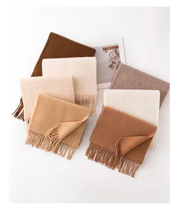 Collection of thick solid-colored wool scarves with tassels in earthy autumn tones