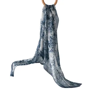 Elegant blue and white toile de jouy printed silk scarf for women shown as a long wrap shawl