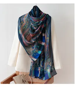 Elegant blue paisley printed mulberry silk long shawl scarf draped over a cream blazer
