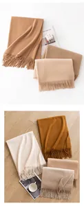 Detail view of 100% cashmere scarves in various earthy tones with fringe detail