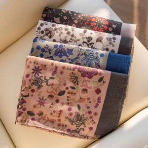 Elegant floral printed imitation cashmere scarves for women in a stack.